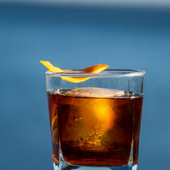 Walnut old fashioned by the water's edge of Lake Superior